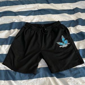 Black Shorts with Cute Butterfly Logo that reads “This story is not finished”